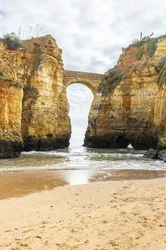 Ponte do Antigo Forte do Pinho Rock Arch at Praia dos Estudantes, Lagos, Al.. Stock Photos