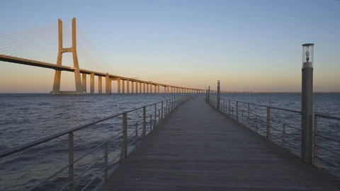Ponte Vasco da Gama Bridge view from a pier at sunset Stock Footage 91558341