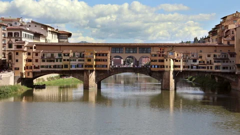 Ponte Vecchio bridge Florence river POV sky clouds with tourists crossing 動画素材 294981436