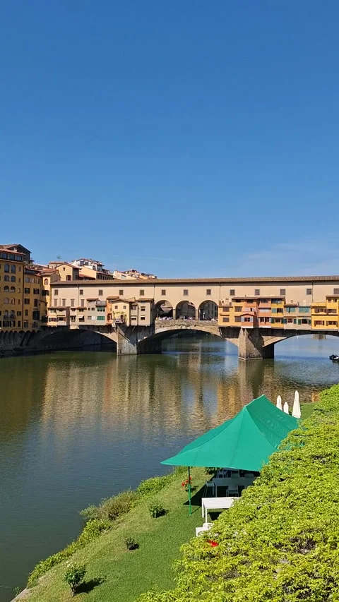 Ponte Vecchio Bridge reflecting on the Arno River in Florence, Italy Stock Footage 344669793