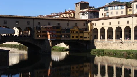 Ponte Vecchio reflected on the Arno river, Florence, Italy.  Tilt-Up HD Video Stock Footage 98155778