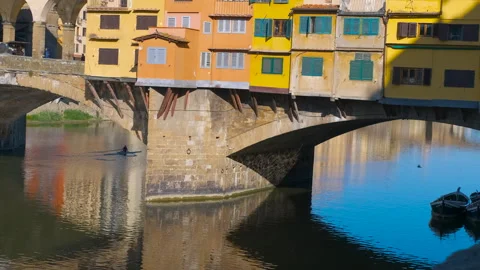 Ponte vecchio reflecting on arno river with kayaker in florence Stock Footage 327484047
