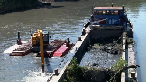 A pontoon excavator threw mud into the river barge Video stock 137065817