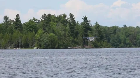 Pontoon plane lands on lake Stock Footage 52193166