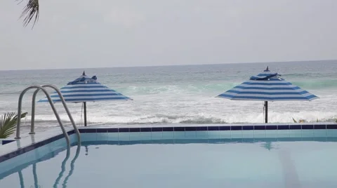 Pool against sea with umbrellas Video stock 64336836
