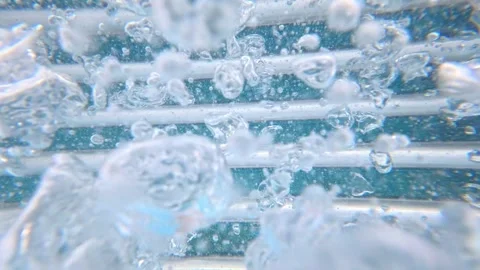 Pool air bubbles rising past metal grate underwater near steps Stock Footage 342156660
