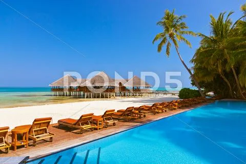 Pool and cafe on Maldives beach Stock Photos