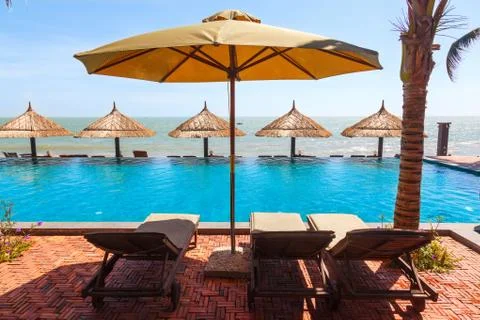Pool and umbrellas on the sky Stock Photos