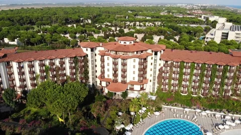 Pool area, lounge zone and hotel buildings, and view over Belek resort Stock Footage 172446281