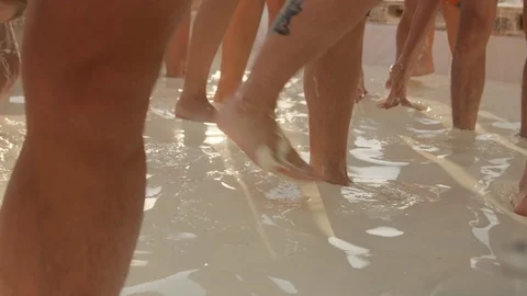 Pool attraction .Lots of people in the pool.Close - up of feet in the pool 動画素材 115477270