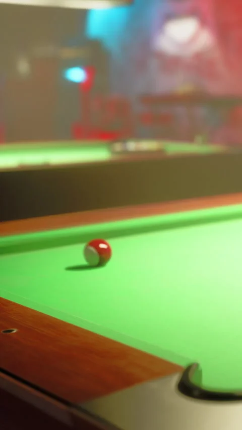 Pool ball rolls on green table in bar during evening hours Stock Footage 340879150