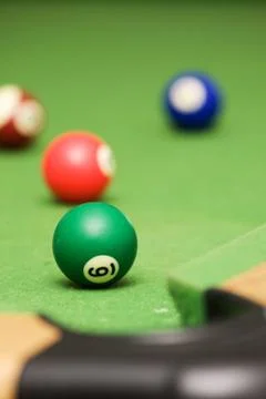 Pool balls on a green pool table Stock Photos