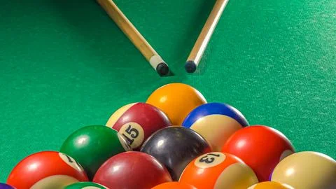 Pool balls on the table with two cue Stock Photos