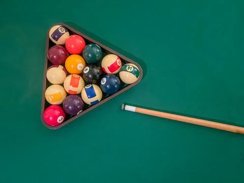 Pool balls in triangle and cue on green pool Stock Photos