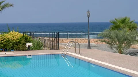 Pool with blue turquoise water on background of sea. The concept of summer Stock Footage 134615866