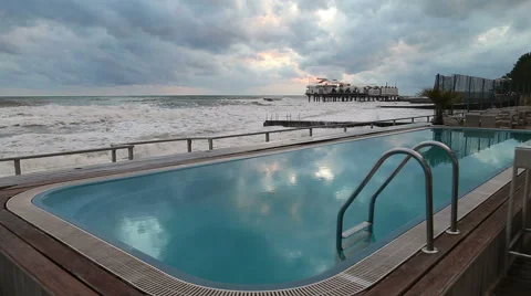 Pool with blue water on the beach in Sochi amid storm in the Black sea Vidéo 48986648