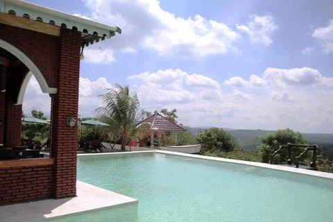 A pool with a brick wall and a white roof Stock Photos