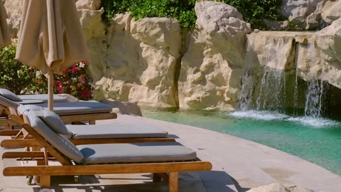 Pool chairs egypt, a small artificial waterfall on site Stock-Footage 240200275