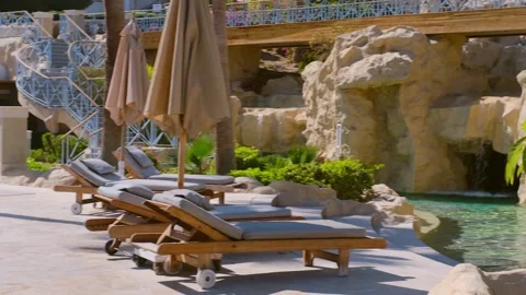 Pool chairs egypt, a small artificial waterfall on site Stock-Footage 240200585