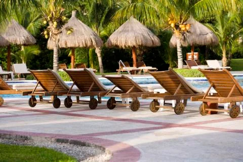 Pool Chairs Lined Up Beside Pool Stock Photos