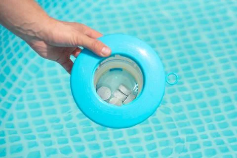 Pool chlorine tablets to keep the water of the home pool clean Stock Photos