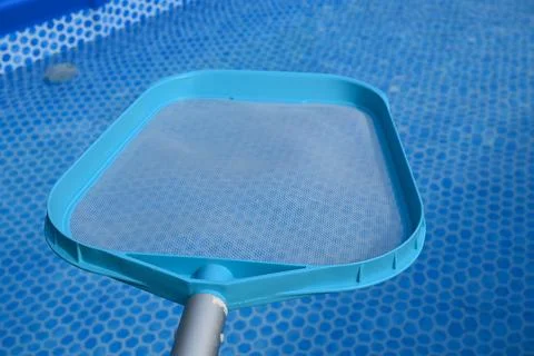 Pool cleaning net over blue pool liner Foto stock