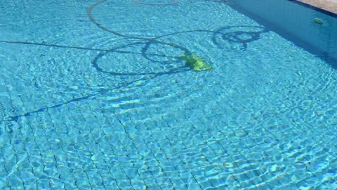 Pool cleaning, pool vacuum cleaner cleans and vacuums the bottom of the pool Stock Footage 130512143