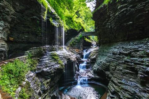 A pool with clear water formed by a cascade of waterfalls of a small river .. Stock Photos