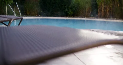 Pool Cover Slides Slowly Over the Blue Pool in the Morning Vídeo Stock 340260360