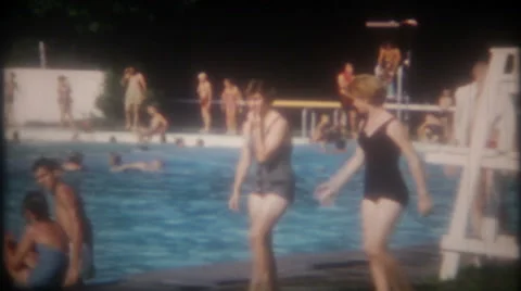 Pool crowded with swimmers and sunbathers 1950s vintage film home movie 3723 Stock Footage