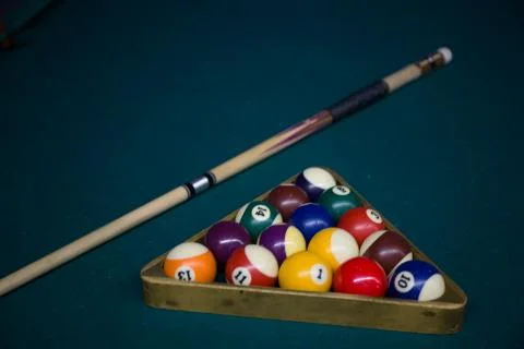 Pool Cue and triangle Rack on green pool table Stock Photos
