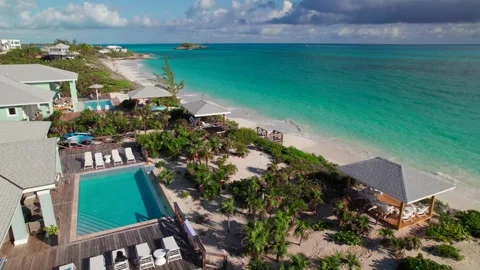 Pool deck at luxury Bahamian beachfront villa, 4K aerial Stock Footage 334818512