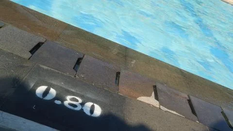 Pool depth sign, Water depth mark on pool edge Stock Photos