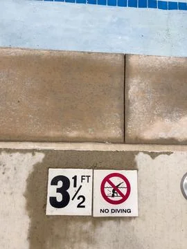 Pool Edge Showing Depth and Rules Stock Photos