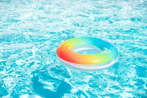 Pool float, ring floating in a refreshing blue swimming pool on summer Stock Photos