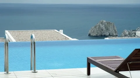 A pool with flowing water on the background of sea and mountains Stock Footage 83563429