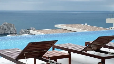 A pool with flowing water on the background of sea and mountains Stock Footage 83563441