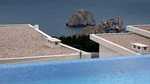 A pool with flowing water on the background of sea and mountains Stock Footage 83563495