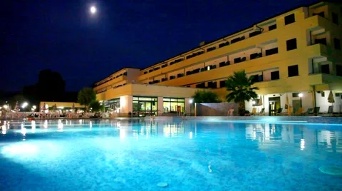 Pool in front of hotel at night Stock Footage 5296073