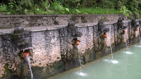 Pool with hydrogen sulphide water. A stream of water flows from stone figures in Video stock 91879329