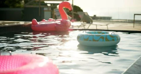 Pool, inflatables and hotel with empty resort for holiday vacation, reflect.. Stock Photos