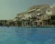 Pool level view of swimming pool and resort building SD Footage