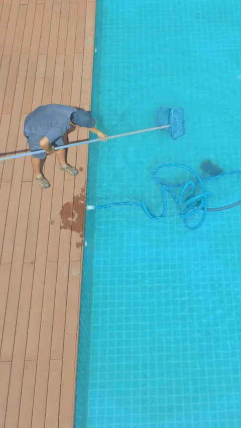 Pool maintenance with scoop net and automatic robot cleaner. Stock Footage 278028586