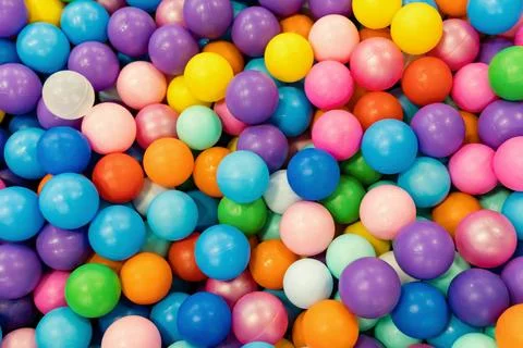 Pool of multicolored balls in close-up. Entertainment for children in the chi Stock Photos