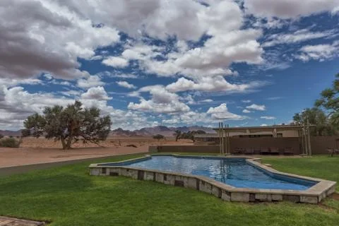 Pool overlooking the mountains of the Namibia desert. Stock Photos