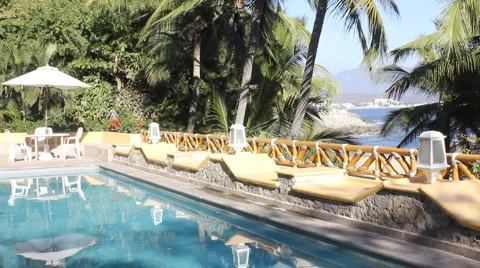 Pool overlooking tropical beach and palm trees Stock Footage 1071828