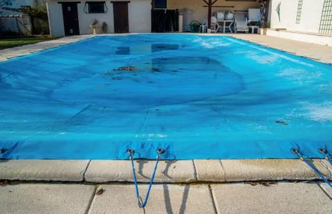 Pool protected by a pool cover during winter months Stock Photos