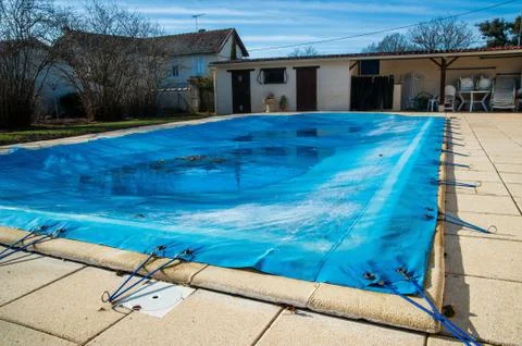 Pool protected by a pool cover during winter months Stock Photos