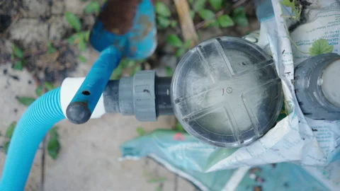 Pool pump working next to blue garden shovel - purification and maintenance of Stock Footage 209548008