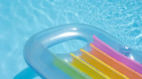 Pool Raft Floating on the Surface of a Swimming Pool Stock Footage 64111921